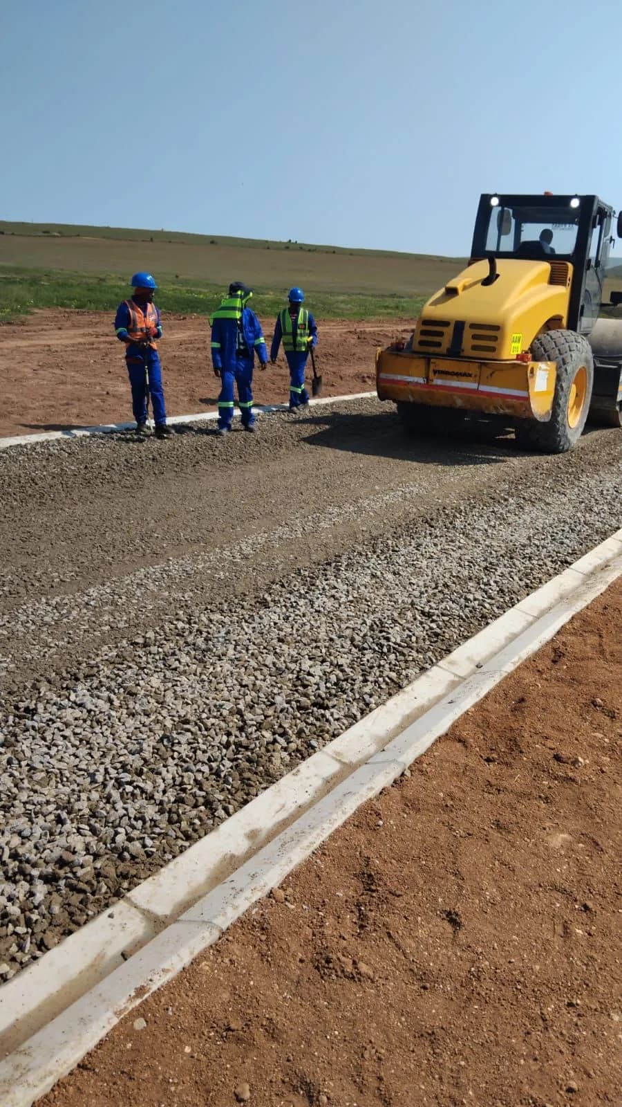 Heavy roller compacting a road base