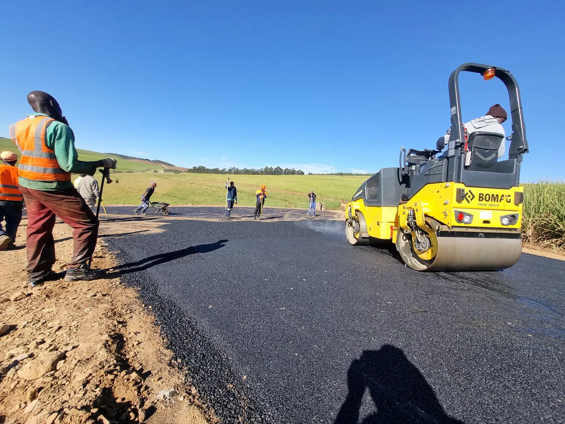 Tandem roller compacting new asphalt