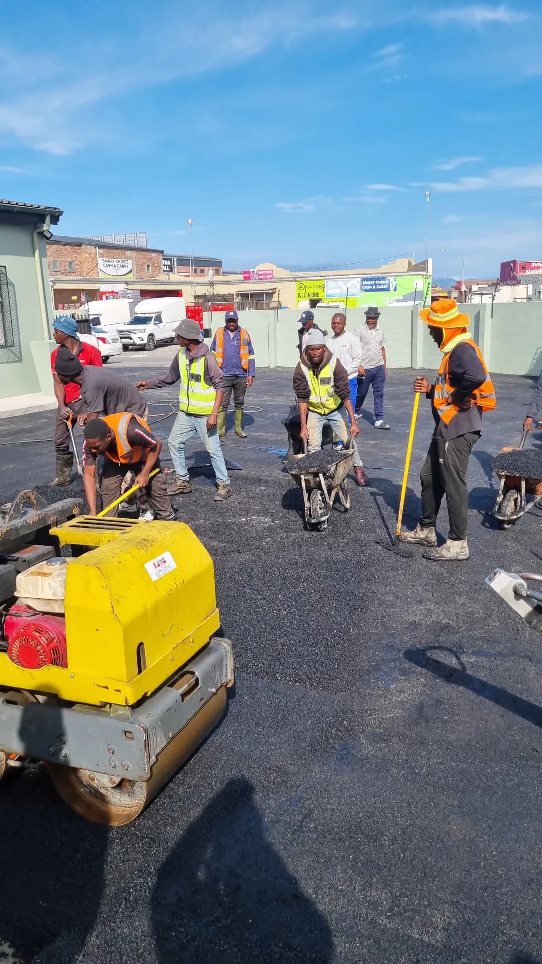 Plate compactor and hand tools on new yard asphalt
