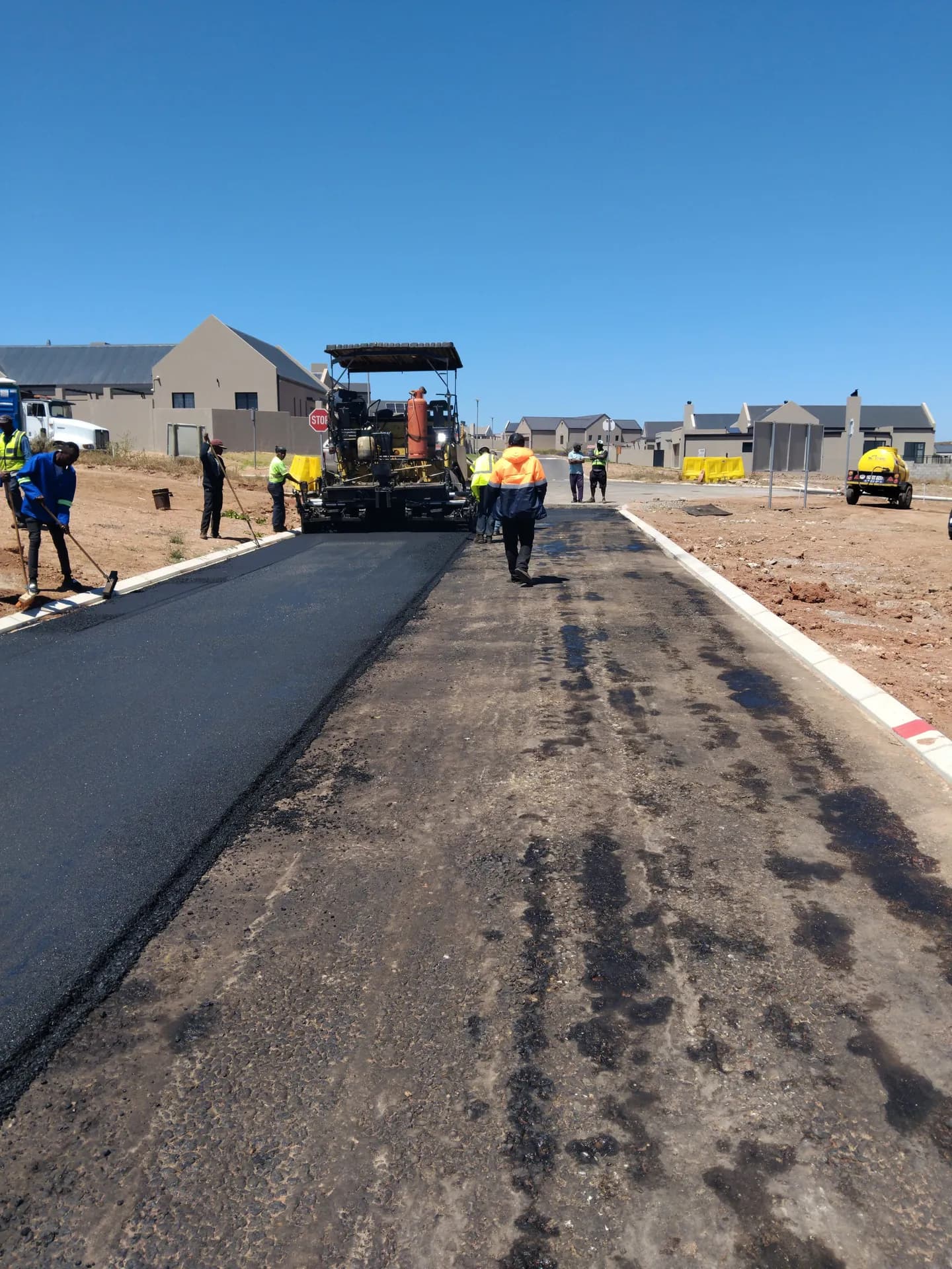 Asphalt paver laying a new residential road